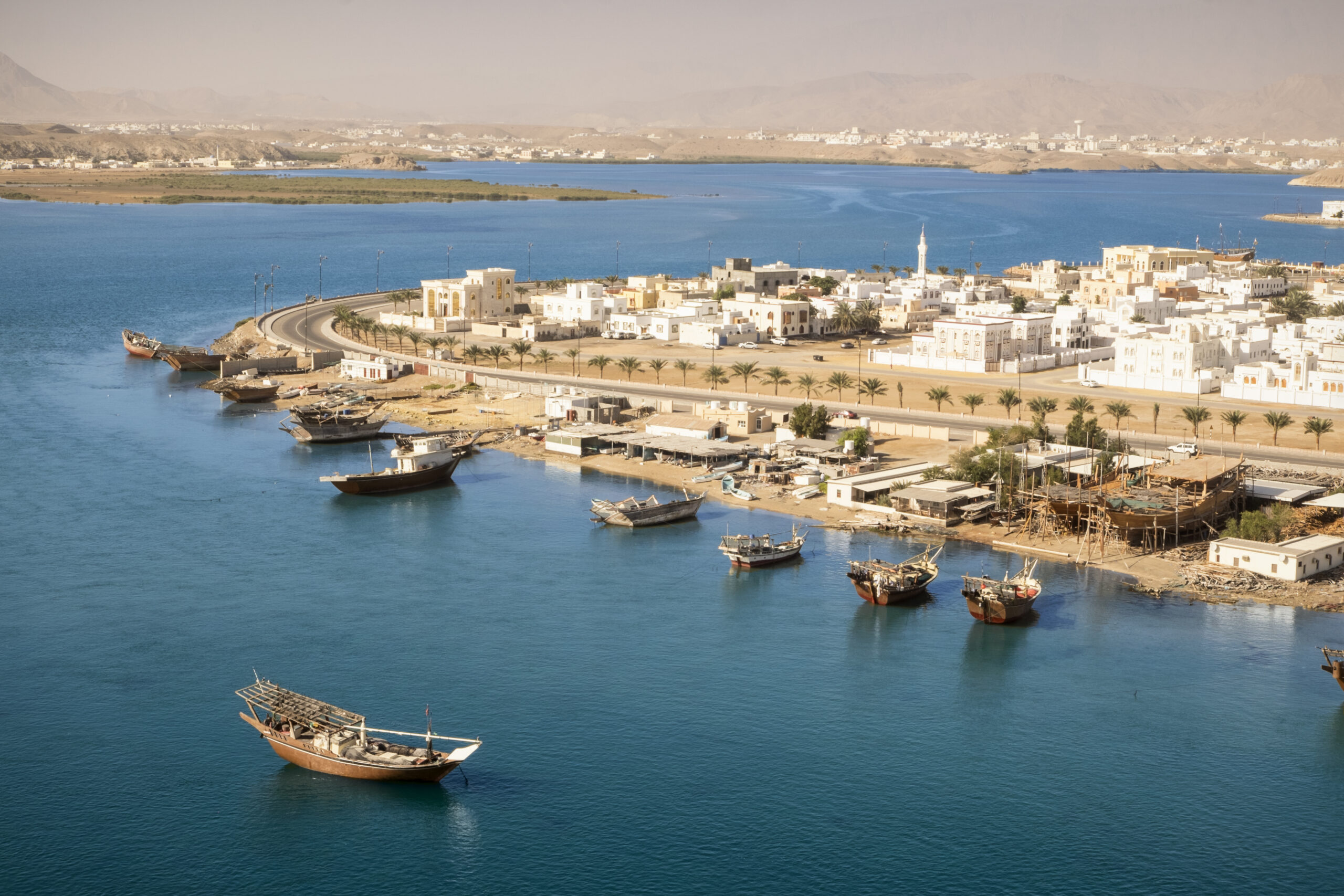 View looking out over Sur in Oman with traditional wooden Dhow ships.